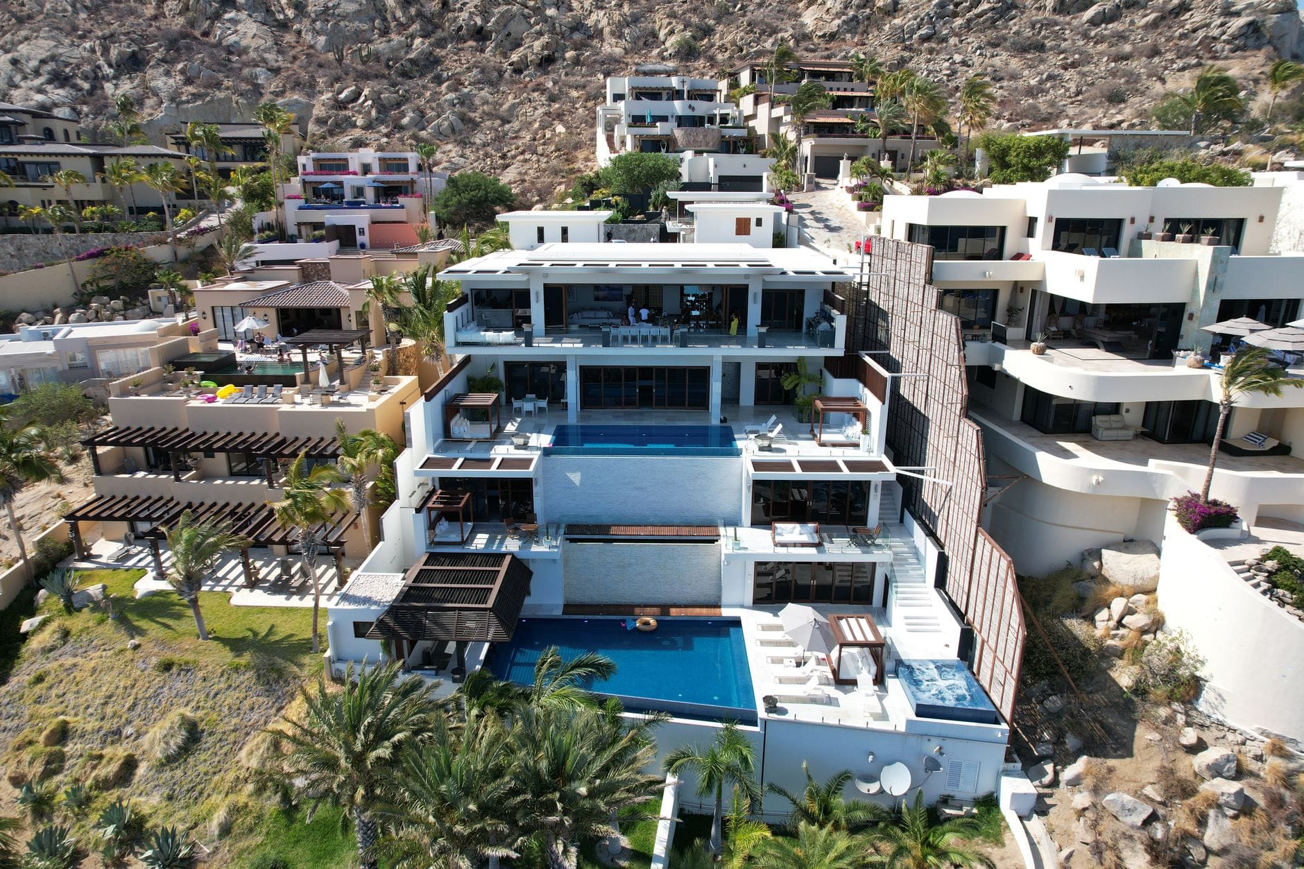 Aerial view of stunning modern villas in Cabo San Lucas with ocean views. — Woods Cove real estate