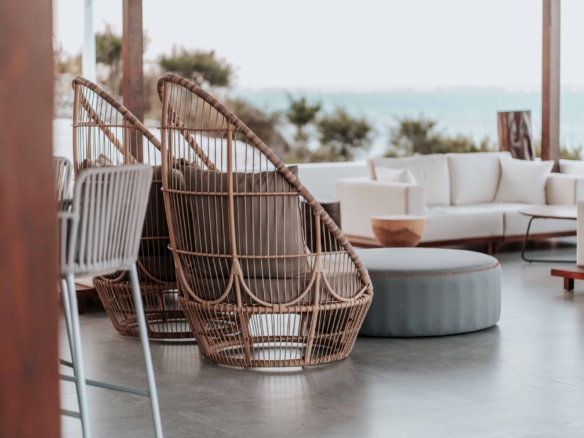Stylish outdoor terrace featuring wicker chairs and sofas by the sea. — Dana Point real estate
