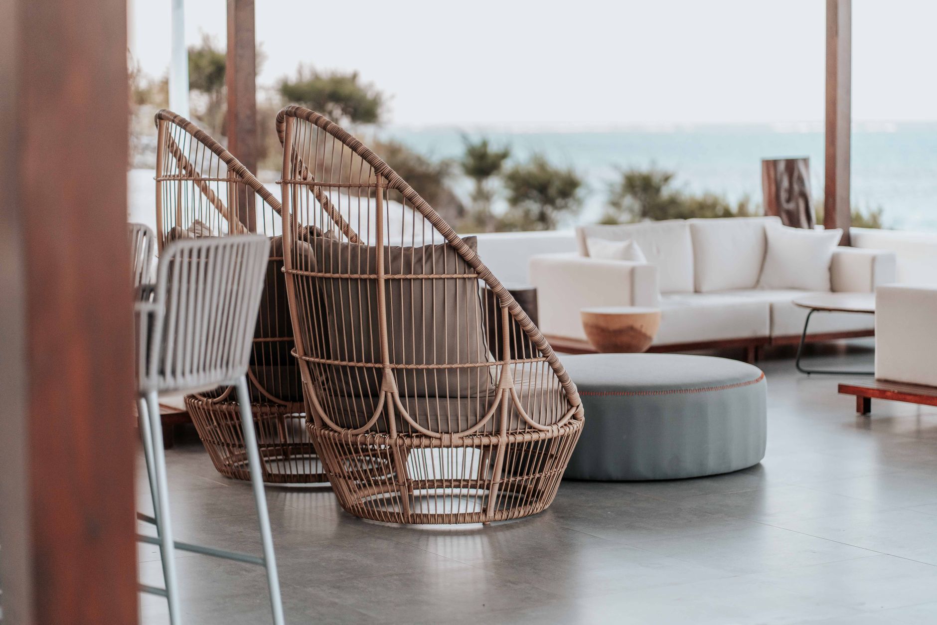 Stylish outdoor terrace featuring wicker chairs and sofas by the sea. — Dana Point real estate