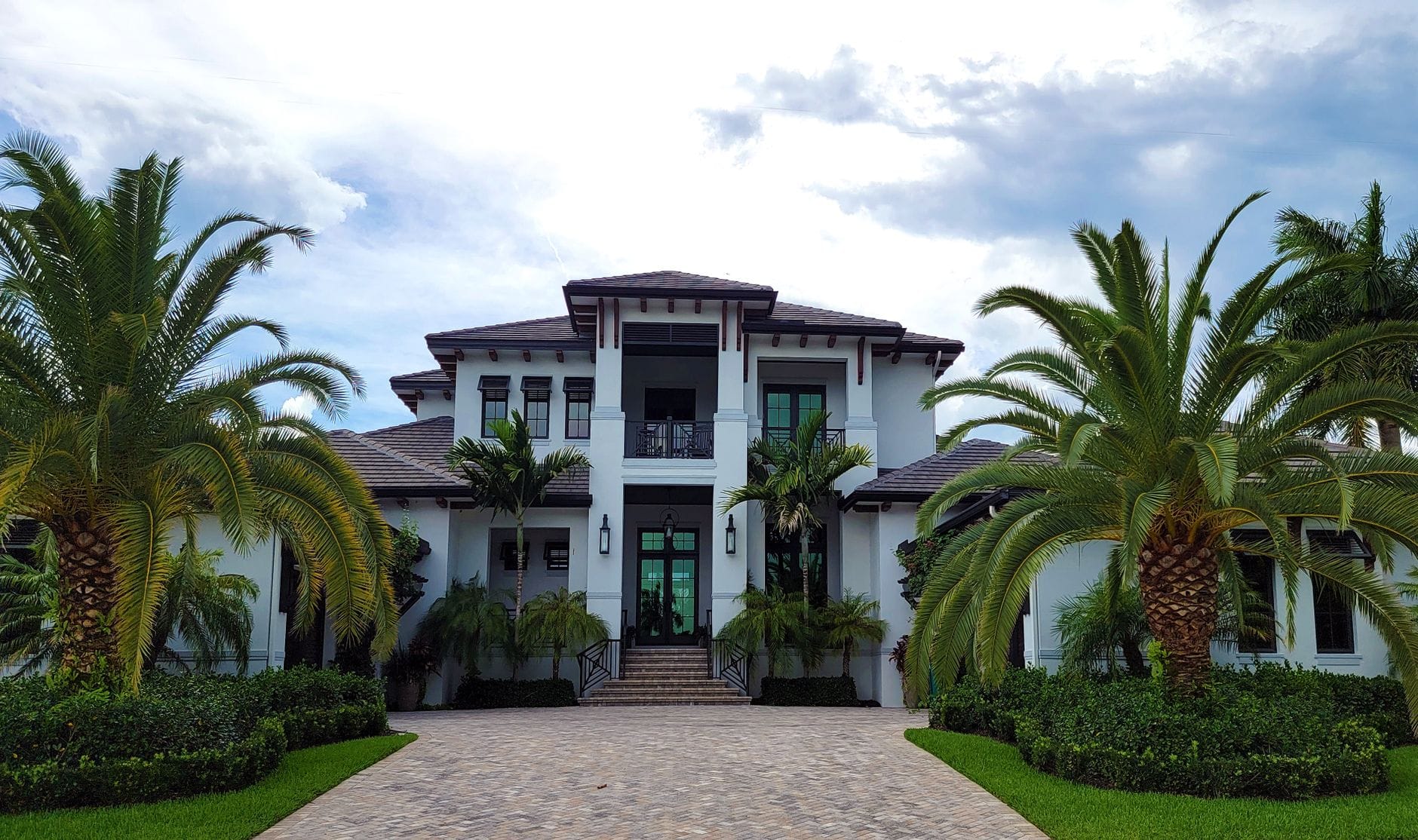 A stunning modern residential building with palm trees and clean architectural design. — South Laguna real estate