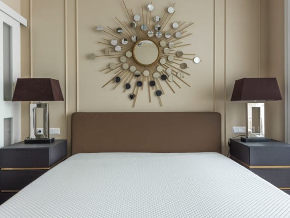 Modern bedroom featuring a minimalist design with stylish decor and furniture. — Emerald Bay real estate