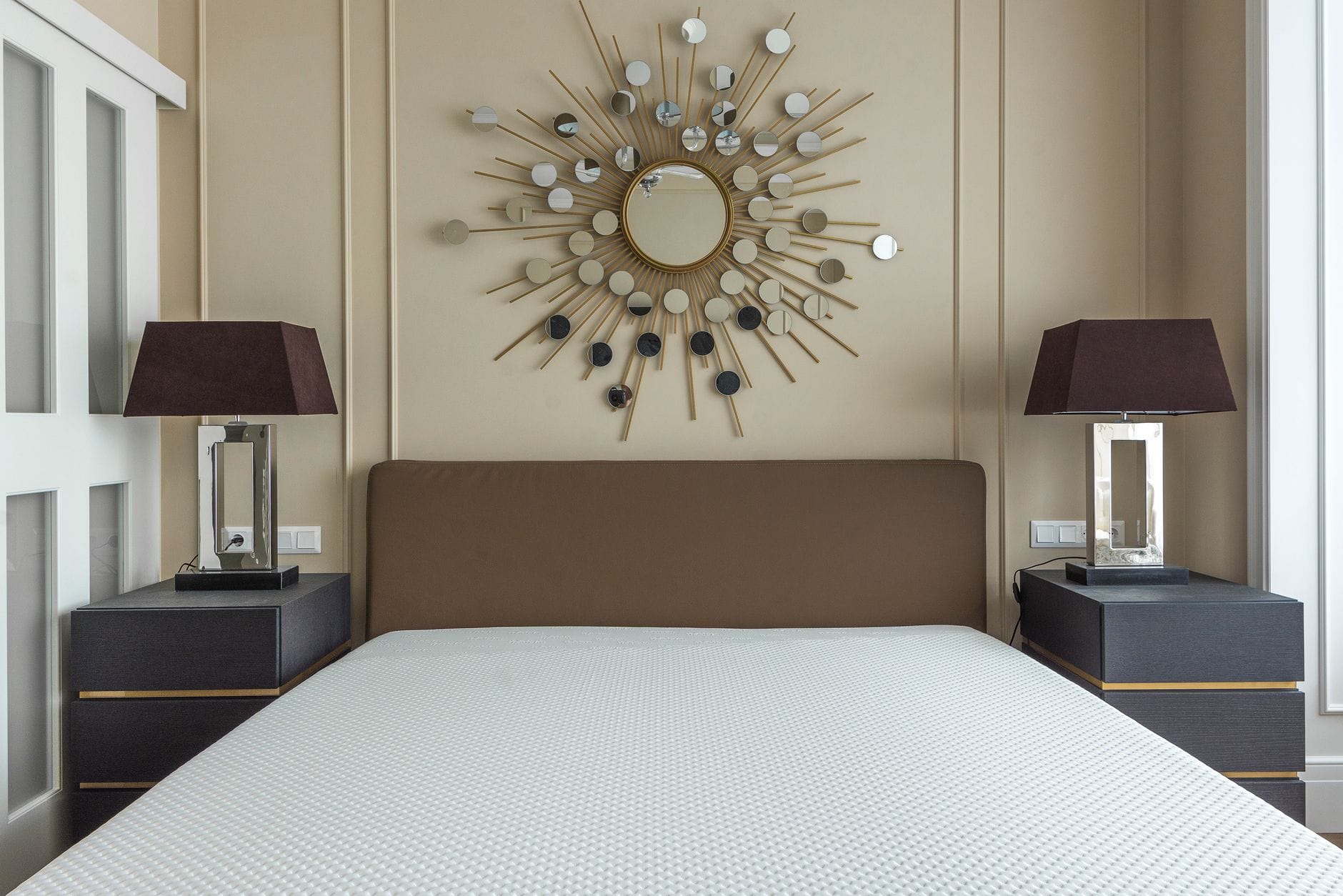 Modern bedroom featuring a minimalist design with stylish decor and furniture. — Emerald Bay real estate